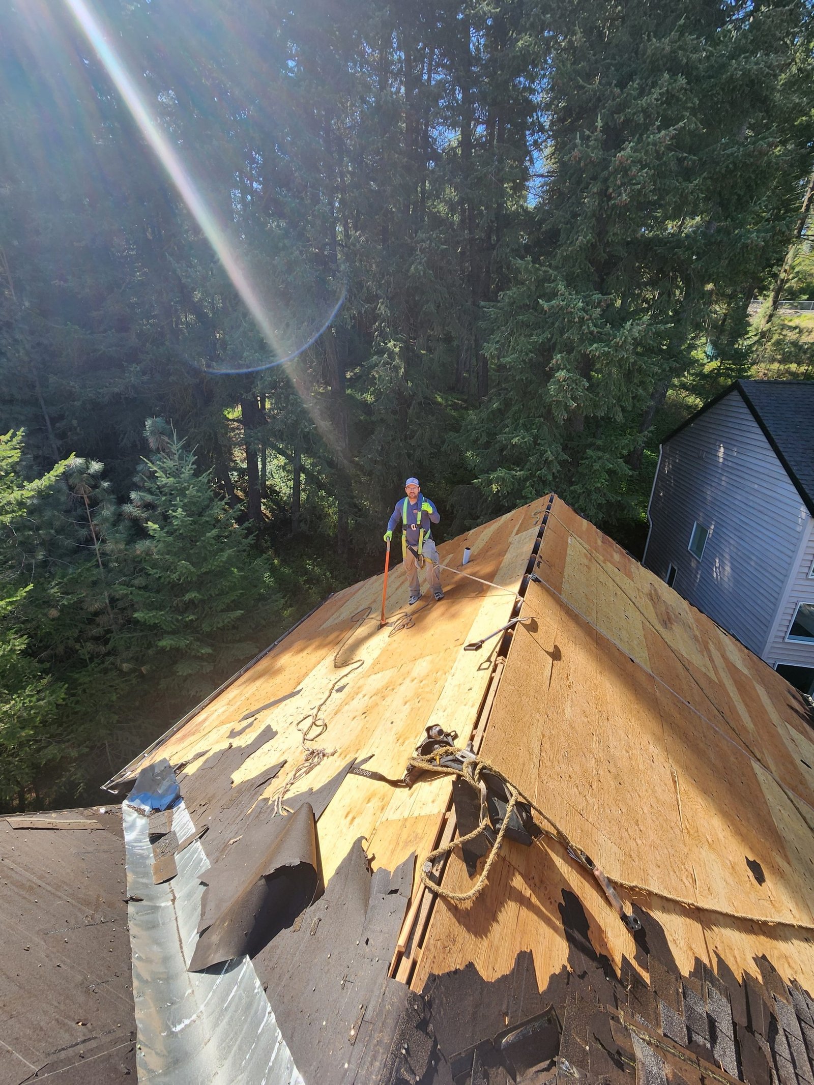 RC Roofing crew installing underlayment on a residential roof