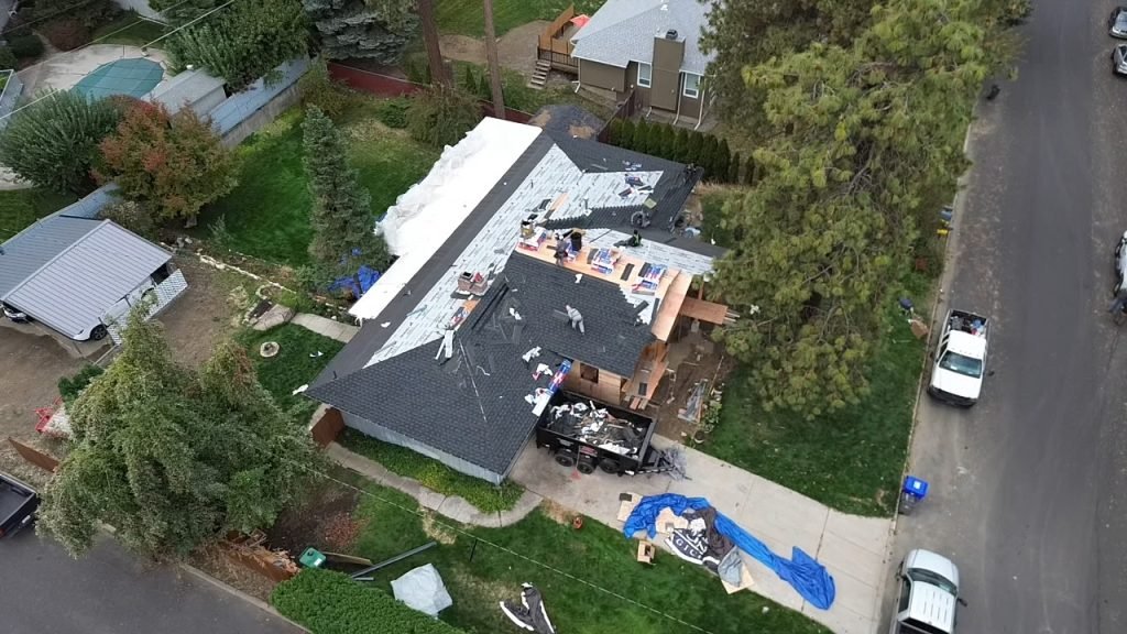 wind damaged roof being repaired by local roofing contractors