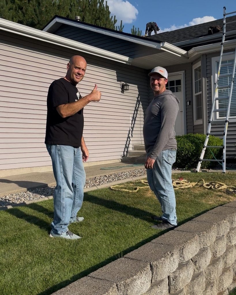 Happy RC Roofing Specialists roof replacement customer smiles at the camera with Josh