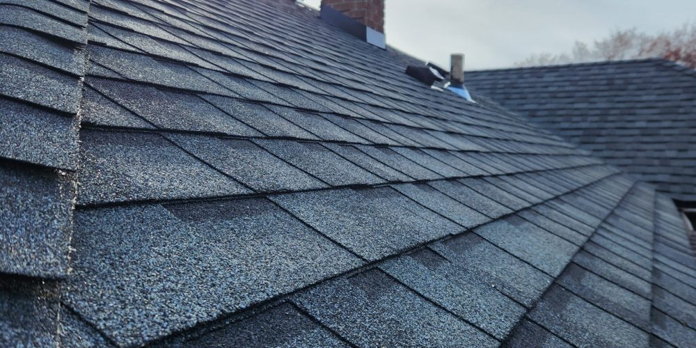 Detailed view of ridge cap and shingle alignment from RC Roofing project